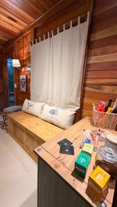 a room with a bed with a window and a table at Cabanas Green Valley in Monte Verde +43 photos