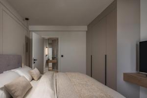 a bedroom with a bed and a tv on a wall at Iman Apartments in Zagreb