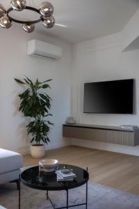 a living room with a tv and a couch and a table at Iman Apartments in Zagreb