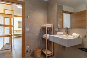 a bathroom with a sink and a mirror at Nest Love, Bedollo Ospitar in Bedollo +31 photos
