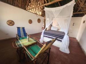 an aerial view of a room with two chairs and a bed at Lemara Eco Camp in Kisaki