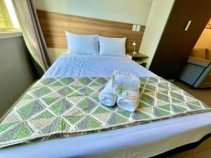a bed with two pairs of shoes on it at Loft near Santa Casa - Apt 604 in Porto Alegre