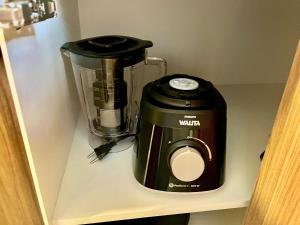 a blender sitting on top of a shelf at Loft near Santa Casa - Apt 604 in Porto Alegre +12 photos
