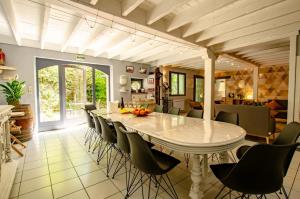 a dining room with a large white table and chairs at La beuillotte in Bar-sur-Seine