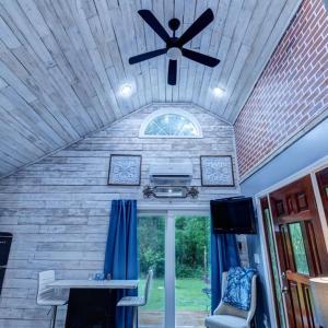 a ceiling fan in a room with a table and a window at Nita's Nest in Foley