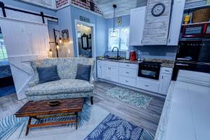 a kitchen with a couch and a coffee table at Nita's Nest in Foley