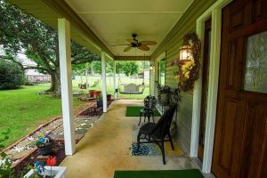 a porch of a house with a ceiling fan at Nita's Nest in Foley +7 photos