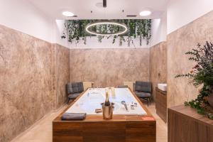 a conference room with a table with a bottle of wine at Hotel Studanka in Rychnov nad Kněžnou