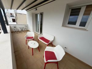 a room with chairs and tables and a window at Suites Prestige in Peschici