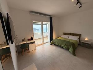 a bedroom with a bed and a view of the ocean at Suites Prestige in Peschici