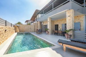 a swimming pool in the backyard of a house at Azure Harmony Pool Villa by SEM in Áyios Spirídhon