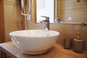 a white sink sitting on a counter in a bathroom at Beausoleil Metro Paris Sud in Le Kremlin-Bicêtre +23 photos