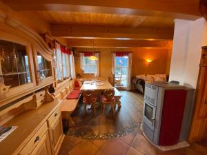 a kitchen with a table and chairs in a room at Pichelhütte in Murau