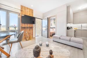 a living room with a couch and a table at Azure Harmony Pool Villa by SEM in Áyios Spirídhon