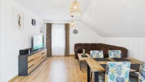 a living room with a couch and a table at Dębówka in Wilcze