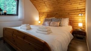 a bedroom with a bed with towels on it at Casa Foresta by Villas Guide in Mrkopalj +35 photos