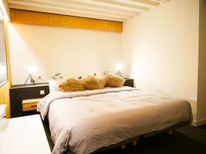 a bedroom with a large white bed with two pillows at The Grand Garden Loft in Pamplona