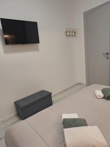 a room with a bed with a flat screen tv on the wall at Delizioso bilocale Paolo in Alassio