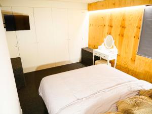 a bedroom with a bed and a sink and a mirror at The Grand Garden Loft in Pamplona +13 photos