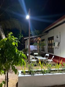 a house with chairs and a table and a street light at Villa 87 in Katunayaka