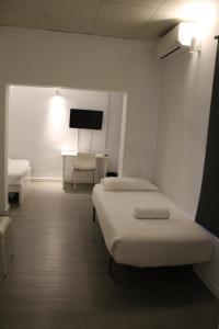 a hospital room with two beds and a desk at Mallorca Rooms Can Pastilla in Can Pastilla