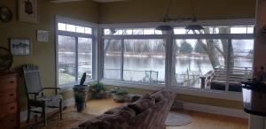 a living room with a couch and a large window at Waterfront the Alcove in Duluth