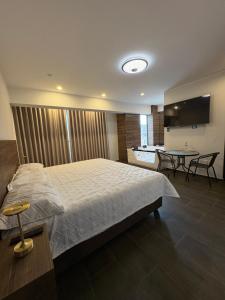 a bedroom with a bed and a table with chairs at Hotel Zaniah in Huancayo