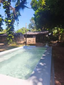 a swimming pool in front of a house at Posada de las Huellas in Loreto