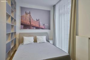 a bedroom with a bed with a picture of a bridge at Dolce Vita Harrachov in Harrachov