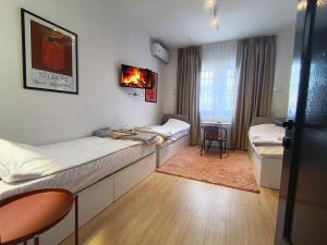a hospital room with two beds and a table at Travel Hub Hostel Social and Friendly in Ohrid