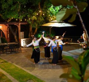 a group of women performing a dance at night at Maida Lodge in Hòa Bình