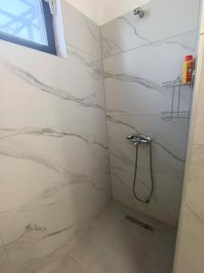 a bathroom with a shower with marble walls at Travel Hub Hostel Social and Friendly in Ohrid