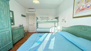 a bedroom with a bed and a bunk bed at Dreamy apartment in Orosei in Orosei