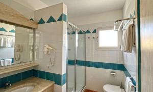 a bathroom with a glass shower and a sink at Dreamy apartment in Orosei in Orosei +9 photos