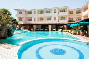 a large swimming pool in front of a hotel at Dreamy apartment in Orosei in Orosei