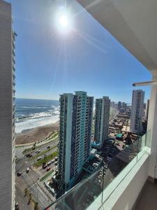 a view of the beach from a balcony of a building at Apartment in Playa Brava Ocean View & SmartLock in Iquique