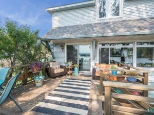 a porch of a house with a wooden fence at Waterfront The Hearding Island in Duluth