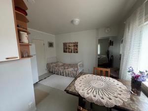 a living room with a table and a bed at Studio Sillankorva in Viitasaari