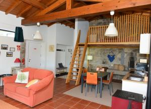 a living room with a orange couch and a table at Quinta da Bela Vista do Lima in Ponte de Lima