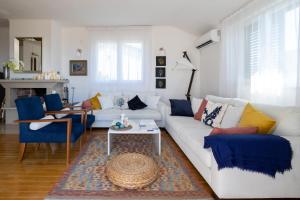 a living room with a white couch and blue chairs at Villa Branko 12km from Dubrovnik in Ravno