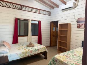 a room with two beds and a window in it at Liahs tortuguero in Tortuguero +24 photos