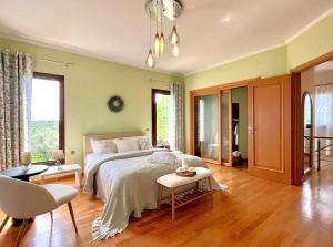 a bedroom with a bed and a table and chairs at Villa Komfort in Zakynthos