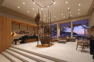 a living room with a grand piano and a living room with at Hotel Indigo La Paz Puerta Cortes by IHG in La Paz