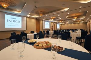 a conference room with a table with wine glasses and food at Hotel Indigo La Paz Puerta Cortes by IHG in La Paz +252 photos