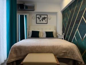 a bedroom with a large bed with a green wall at Luxury rooms Lira in Ogulin