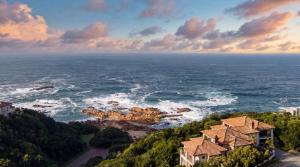 an aerial view of a house and the ocean at Villa Seaview, Private Oceanfront Villa, Heated Pool & Whale Watching Views, Knysna Heads in Knysna