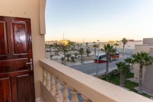a balcony with a door and a view of a street at Erraha Hostel Dakhla in Dakhla
