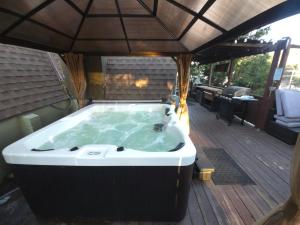 a jacuzzi tub on a deck at Hot Tub A-Frame Cabin Lake Arrowhead Escape in Rimforest +73 photos