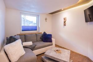 a living room with a couch and a window at Haus Maria Larcher in Bach