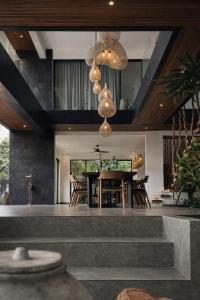 a dining room with a table and some chairs at Oran Villa Bali in Tampaksiring